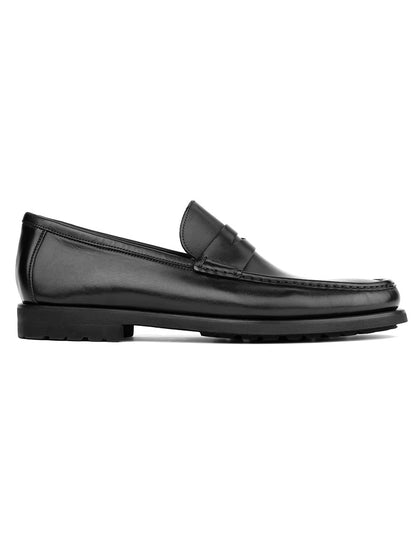The To Boot New York Belfast in Black is an Italian leather loafer with a low heel and rubber sole, ideal for men as a smart casual or dress shoe, shown in profile against a white background.