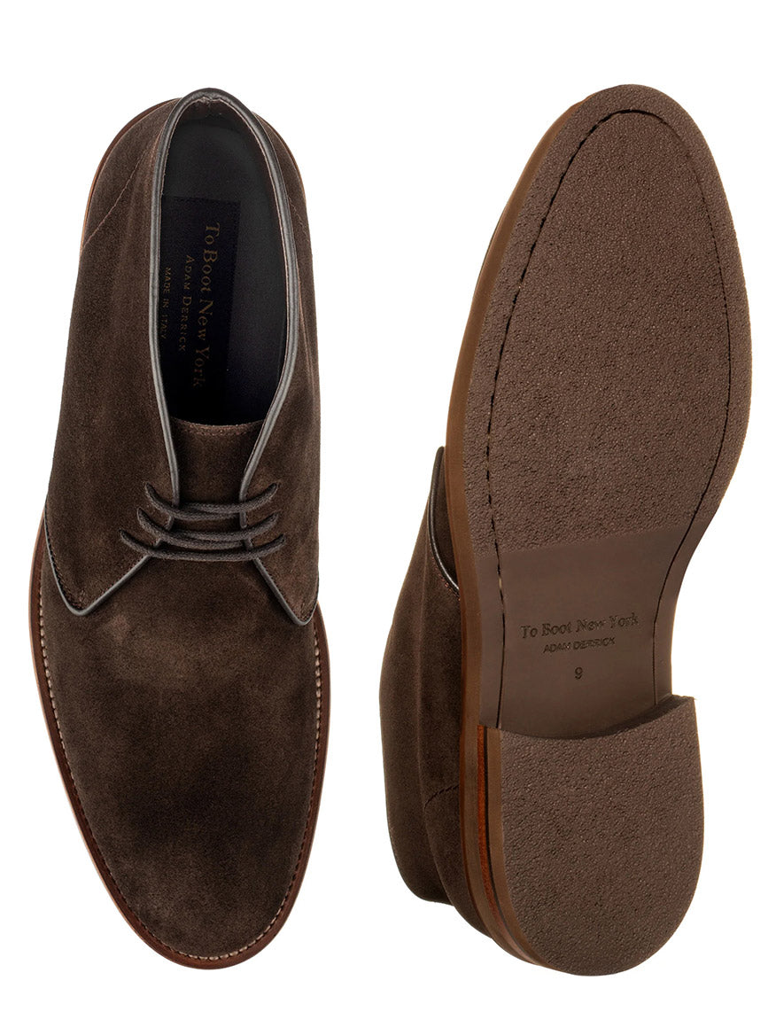 The To Boot New York Monaco Desert Boot in dark brown suede is shown from top and bottom views, featuring leather soles and detailed stitching.