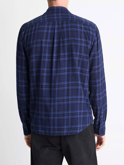 Someone is seen from behind wearing the Vince Big Horn Plaid Cotton Button-Front Shirt in Monarch Combo, featuring blue and black cotton flannel, paired with black pants.