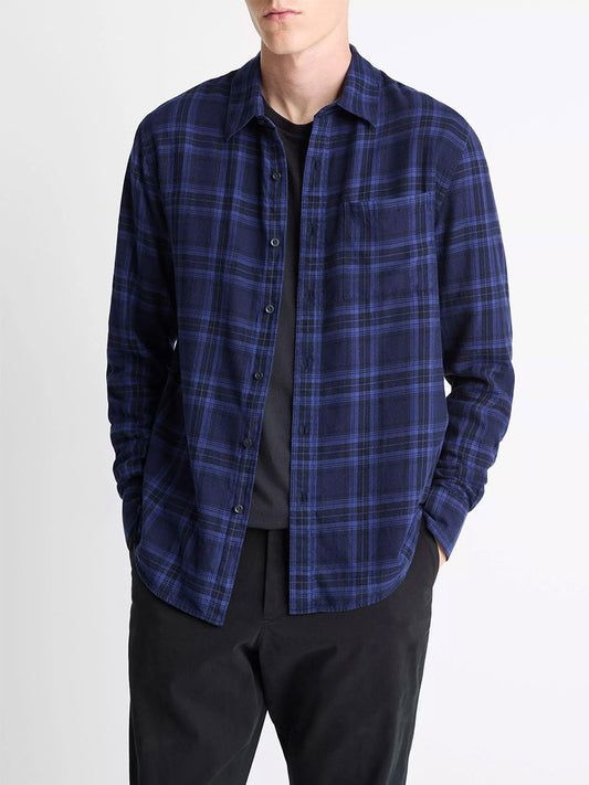 A person wearing the Vince Big Horn Plaid Cotton Button-Front Shirt in Monarch Combo over a black t-shirt and black pants, hands in pockets.