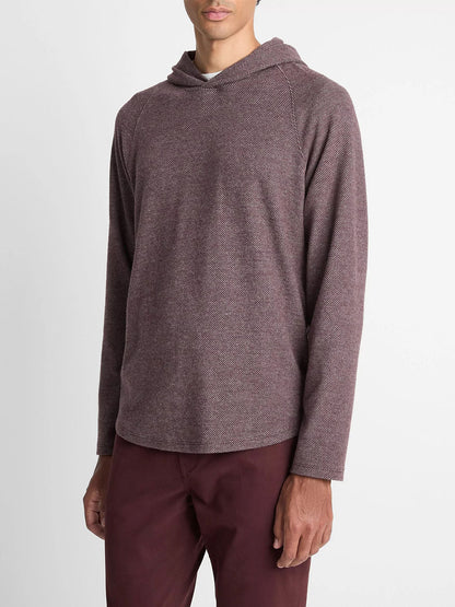 A man wears the Vince Broken Twill Pullover Hoodie in Port/Heather Grey, made from a soft modal and cotton blend, paired with matching pants, standing against a plain white background.