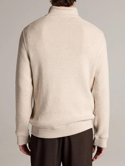 Person wearing the Vince Brushed Cotton-Blend Waffle Quarter-Zip Pullover in Heather Oatmeal and dark brown pants, shown from the back against a plain background.
