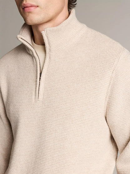 A person wears the Vince Brushed Cotton-Blend Waffle Quarter-Zip Pullover in Heather Oatmeal, shown chest up against a plain background.