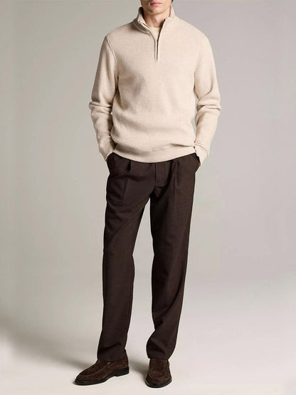 A man wears the Vince Brushed Cotton-Blend Waffle Quarter-Zip Pullover in Heather Oatmeal, paired with dark brown trousers and brown loafers against a plain light background.