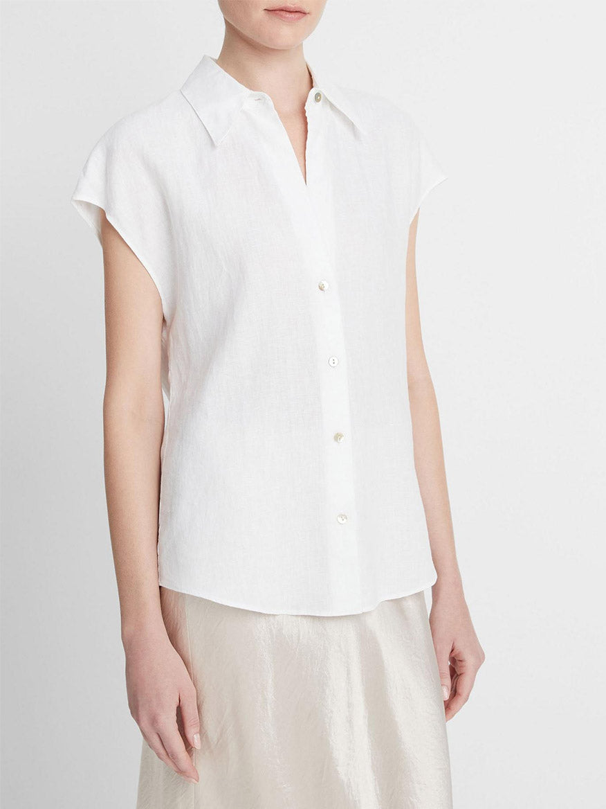 Person wearing a Vince Linen Cap-Sleeve Button-Front Blouse in Optic White and a light-colored skirt.