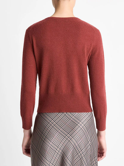 A person is shown from behind wearing the Vince Metal-Button Wool & Cashmere-Blend Cardigan in Siena, paired with a plaid skirt.