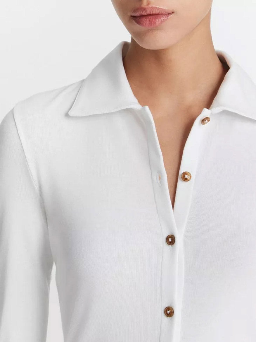 Close-up of a woman in a Vince Long Sleeve Collared Button-Up Shirt in Optic White.