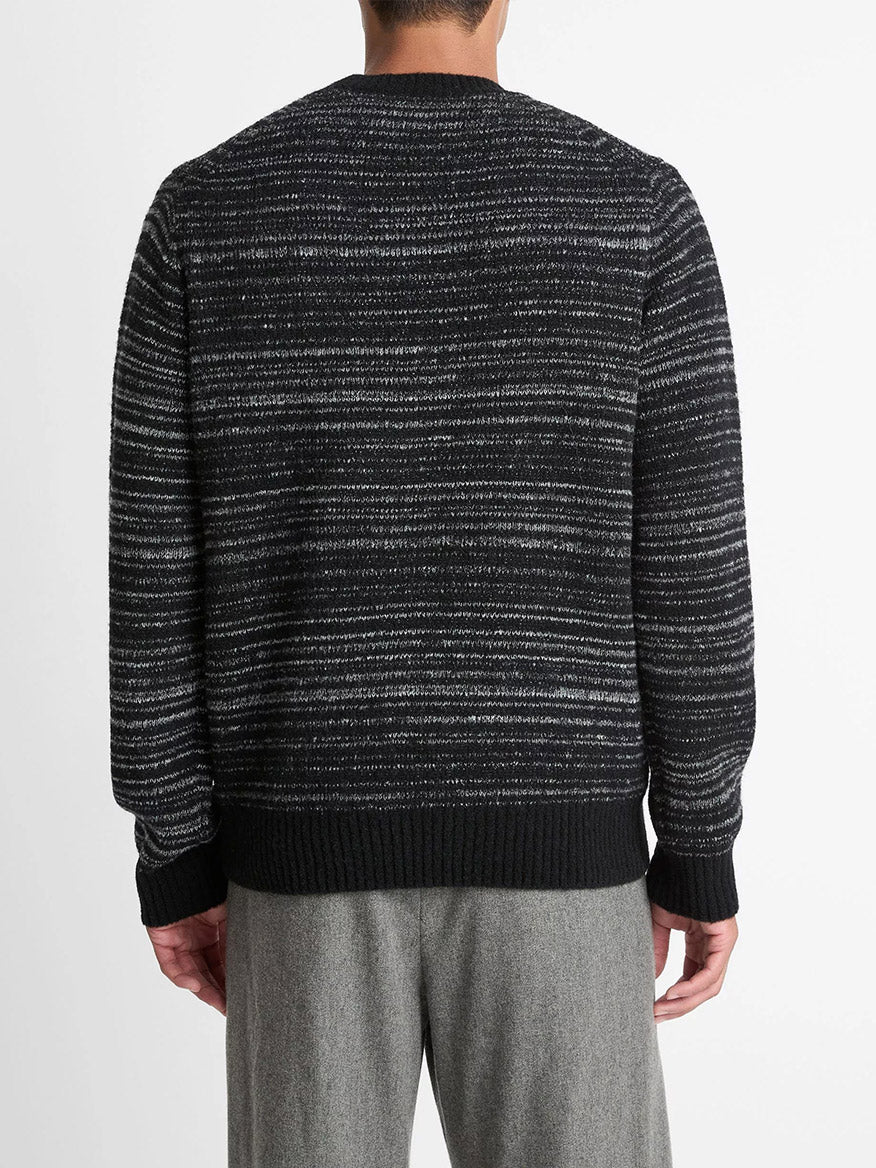 A person is shown from the back wearing a Vince Marled Stripe Merino Wool-Blend Sweater in Black and gray pants against a plain white background.