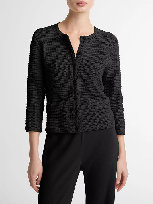 A person wears the Vince Italian Cotton Crochet Cardigan in Black, featuring front pockets and three-quarter sleeves, paired with black pants—ideal for spring layering—against a plain light background.