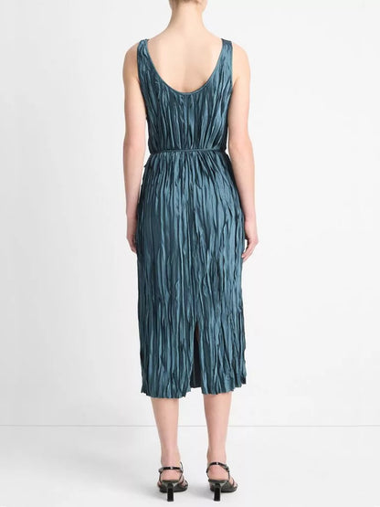 Person wearing a Vince Crushed Satin Bias Tank Dress in Marine Stone, green heels, standing facing away from the camera against a plain white background.