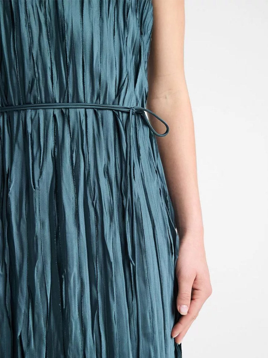 A close-up of a person wearing the Vince Crushed Satin Bias Tank Dress in Marine Stone with a self-tie belt. Only part of the torso and an arm are visible.