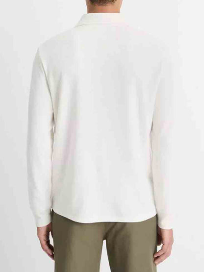 A person wearing a Vince Double Face Long Sleeve Polo Shirt in Cream/Optic White and olive pants stands with their back to the viewer against a plain background, highlighting the understated elegance of Vince's signature style.