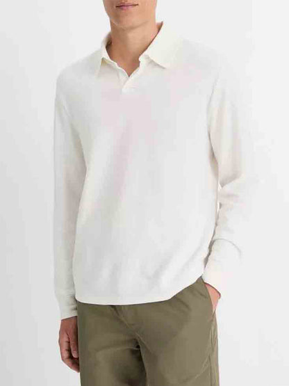 A person wearing a Vince Double Face Long Sleeve Polo Shirt in Cream/Optic White and olive green pants stands against a plain background.