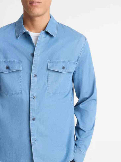 A person wearing the Vince Double Patch-Pocket Cotton Shirt in Washed Waterfall stands against a plain white background.