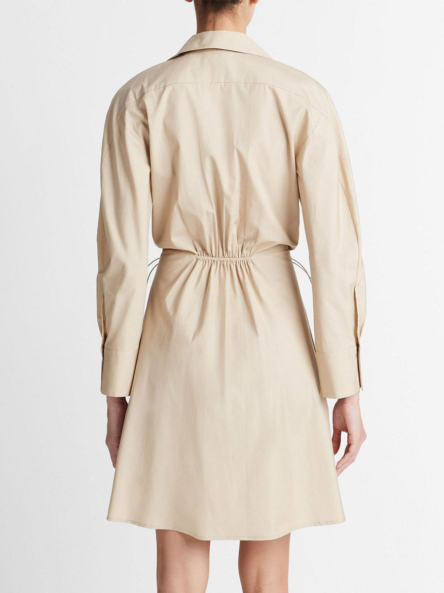 Rear view of a woman wearing a Vince Cotton Drawcord Ruched Shirt Dress in White Oak.