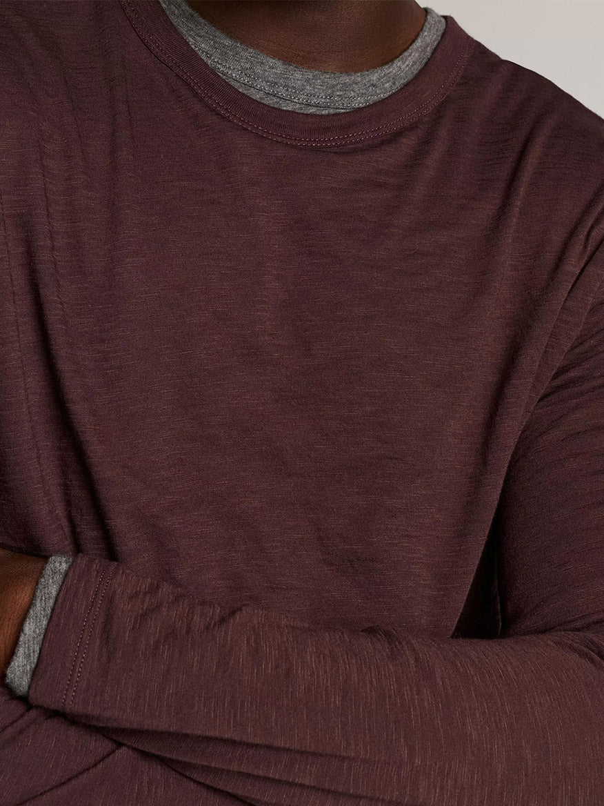 A person wearing the Vince Slub Pima Cotton Double-Layer T-Shirt in Chocolate Plum/Medium Heather Grey, arms crossed.
