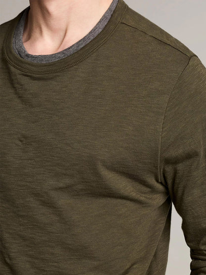 A person shown from neck to upper torso wearing the Vince Slub Pima Cotton Double-Layer T-Shirt in Night Leaf/Medium Heather Grey.