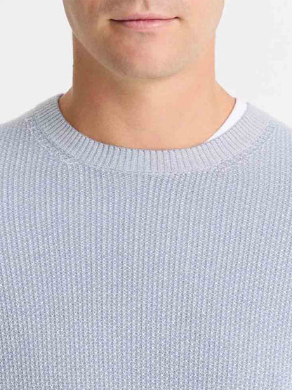 A person wearing the Vince Geo-Jacquard Wool-Blend Crew Neck Sweater in Blue Hour/Classic Cream over a white shirt, visible from the chest up against a plain background.