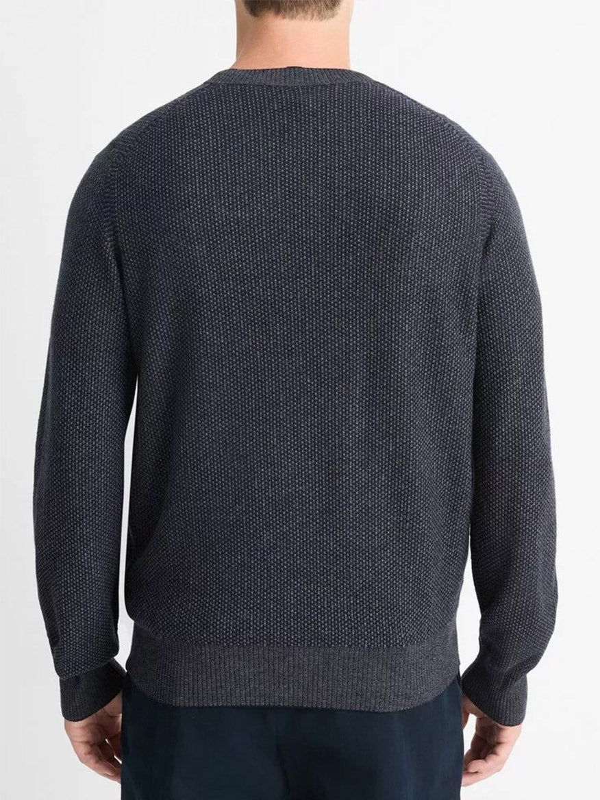 A person wearing the Vince Geo-Jacquard Wool-Blend Crew Neck Sweater in Coastal/Medium Grey, showcasing a textured geometric pattern, is seen from the back against a plain white background.