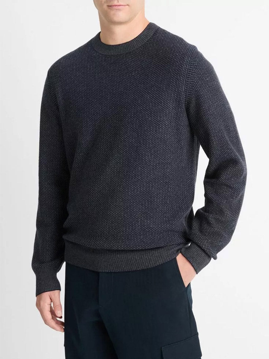 A person wearing a Vince Geo-Jacquard Wool-Blend Crew Neck Sweater in Coastal/Medium Grey, paired with dark pants, stands against a plain background.