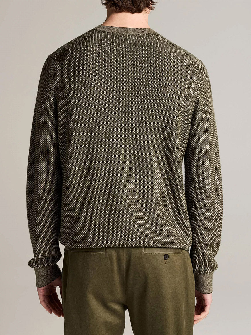 A person seen from behind wears the Vince Geo-Jacquard Wool-Blend Crew Neck Sweater in Midnight Garden/River Sand paired with matching pants, standing against a plain background. The textured sweater is crafted from a luxurious blend of wool, cotton, and cashmere.