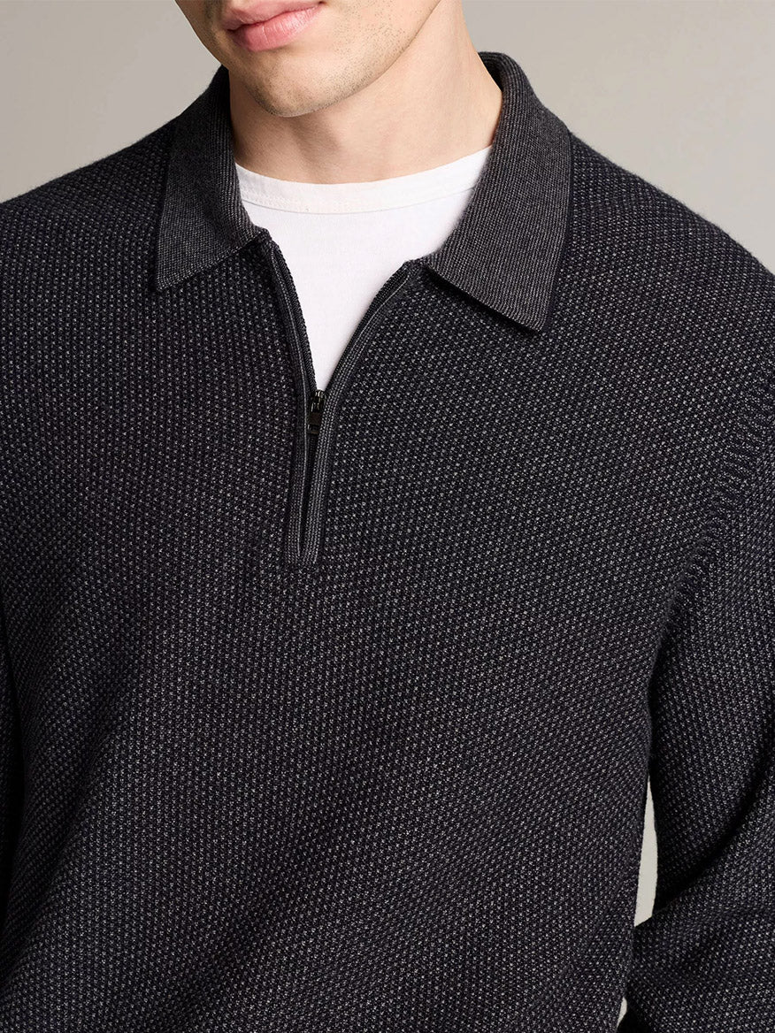 Man wearing the Vince Geo-Jacquard Wool-Blend Zip Polo Sweater in Coastal Blue/Medium Heather Grey over a white crew-neck t-shirt, with a neutral background.