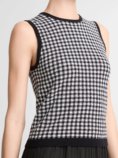 Person wearing the Vince Gingham Italian Wool Blend Shell in Black/Off-White, a sleeveless knit top crafted from a transitional weight wool-cotton blend, featuring black trim on the collar and armholes.