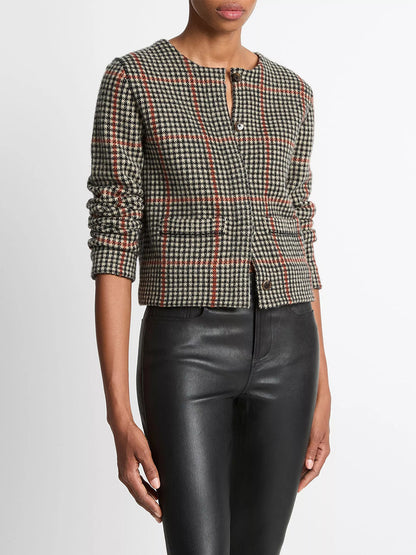A person wearing the Vince Glen Plaid Wool-Cashmere Cardigan Jacket in Cobblestone/Black Combo, styled with high-waisted black leather pants.