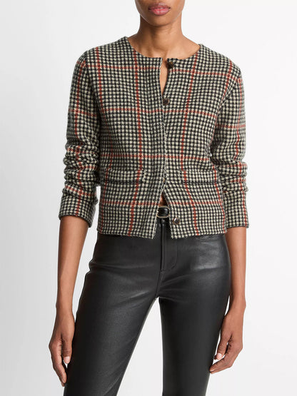 A person wears the Vince Glen Plaid Wool-Cashmere Cardigan Jacket in Cobblestone/Black Combo with black faux leather pants, standing against a plain white background.