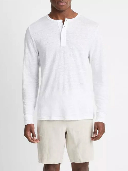 Man wearing a Vince Linen Long Sleeve Henley in Optic White shirt and beige shorts.