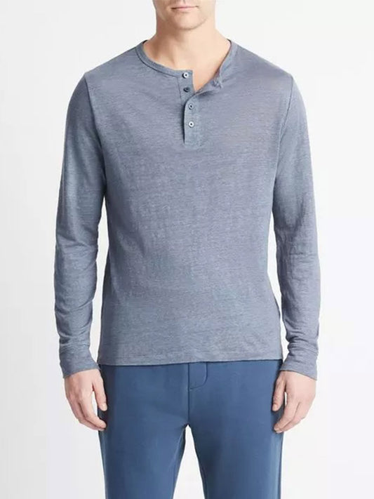 Man wearing a Vince Linen Long Sleeve Henley in Washed Indigo shirt and blue pants.