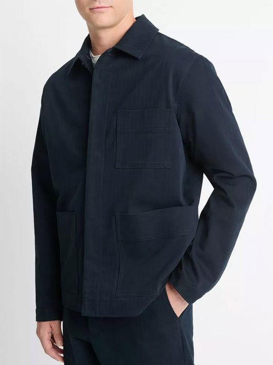 A man wearing a Vince Herringbone Cotton Chore Jacket in Coastal, featuring two large front pockets and crafted from herringbone-weave cotton.