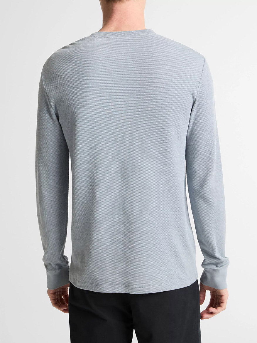 A person wearing a Vince Jacquard-Rib Cotton Henley in Steel Blue and black pants is shown from the back against a plain background.