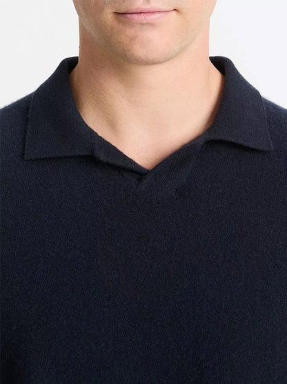 A person wearing a Vince Plush Cashmere Johnny-Collar Polo in Coastal, seen from the shoulders up, displays a neutral expression.