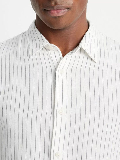 Close-up of a person wearing a Vince Bayside Stripe Linen Long-Sleeve Shirt in Optic White/Deep Indigo.