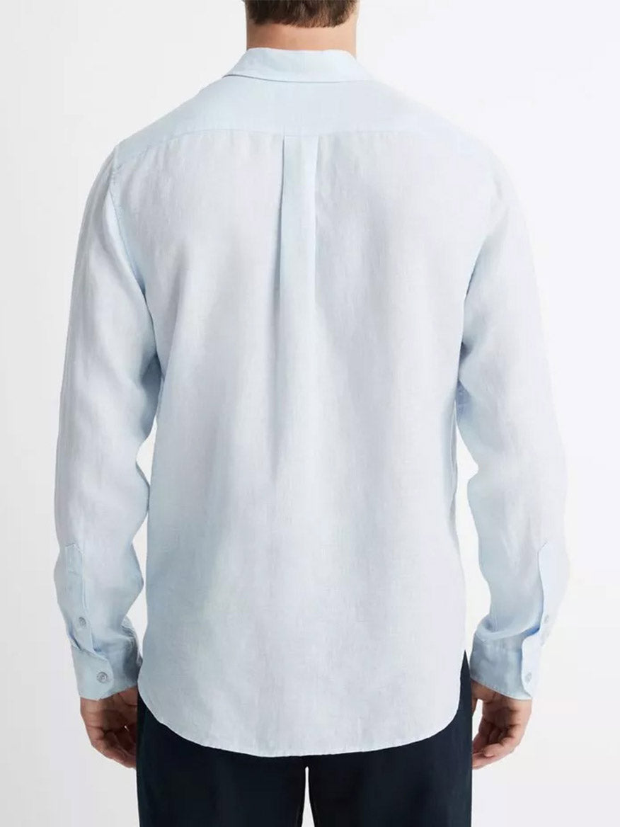 A man viewed from behind wearing a Vince Linen Long Sleeve Shirt in Glacier with a pleat detail on the back.