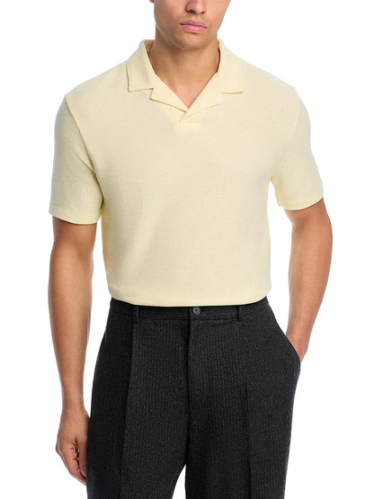 A man wears the Vince Macro Honeycomb Cabana Johnny Collar Shirt in Cream paired with dark gray dress pants, standing with one hand in his pocket.