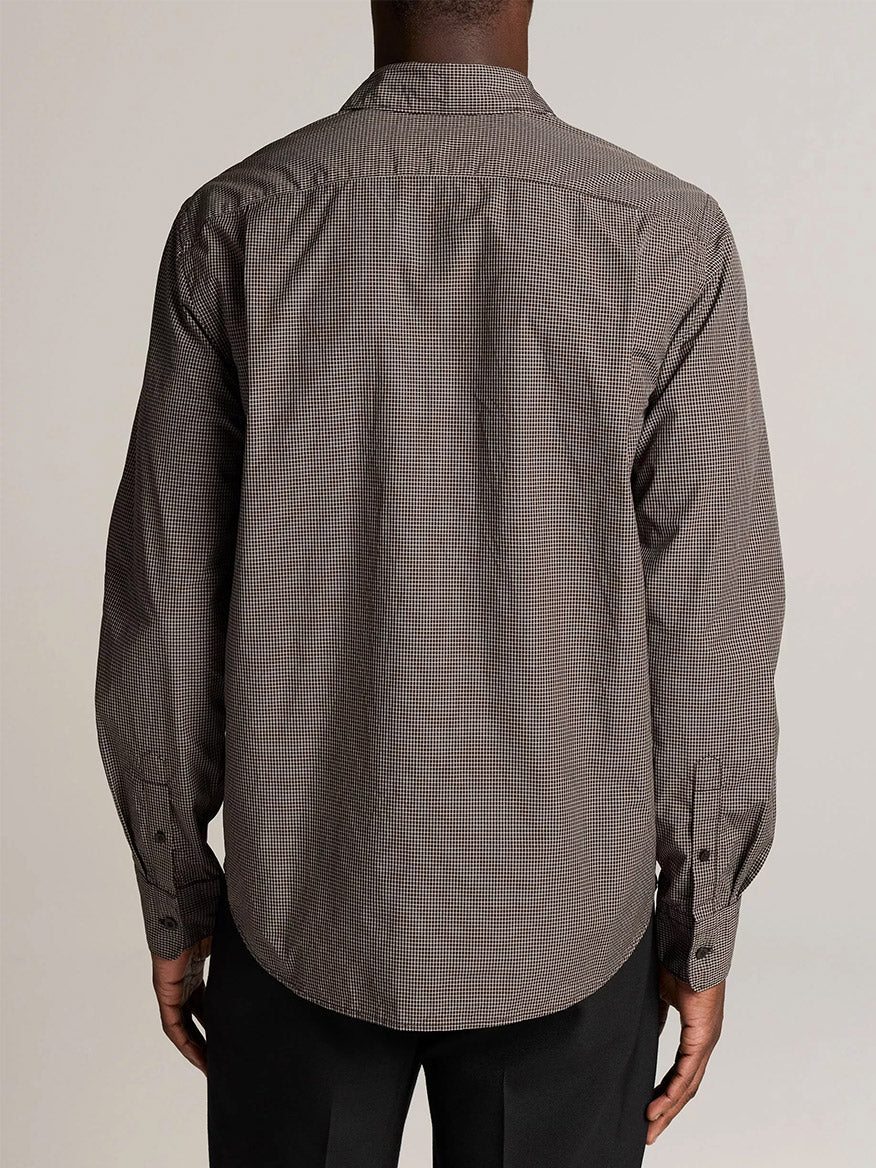 A person is shown from the back against a plain, light background, wearing the Vince McDermott Plaid Cotton Button-Front Shirt in Arabica/Headline Grey and black pants.