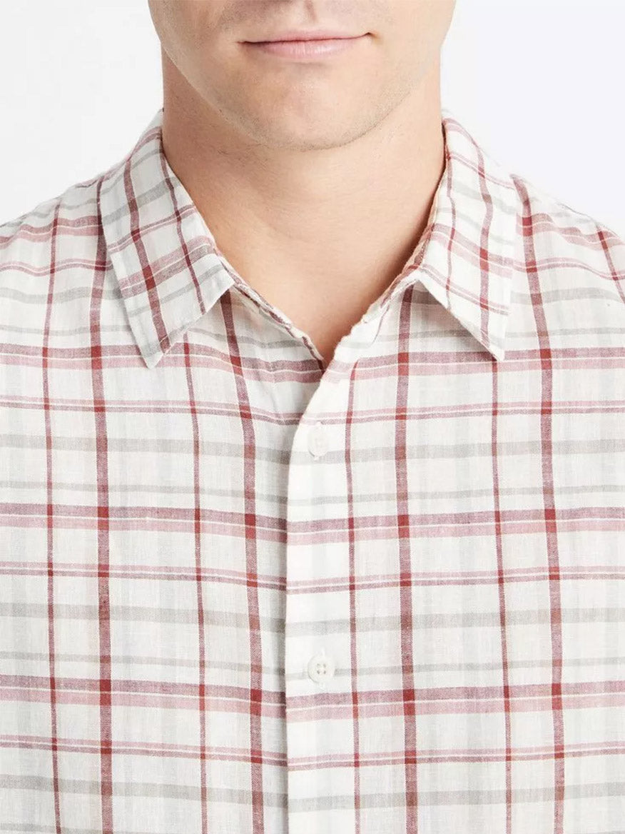 Partial view of a person wearing a Vince Oakmont Plaid Long-Sleeve Shirt in Alabaster/Dried Cactus.