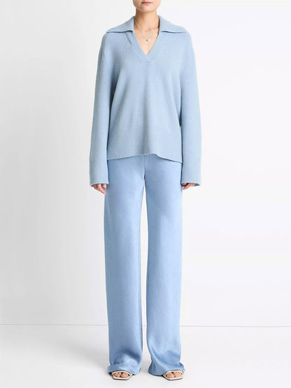 Person wearing the Vince Wool & Cashmere-Blend Oversized Polo Sweater in Pacific with matching wide-leg pants and open-toe shoes, standing against a plain white background.