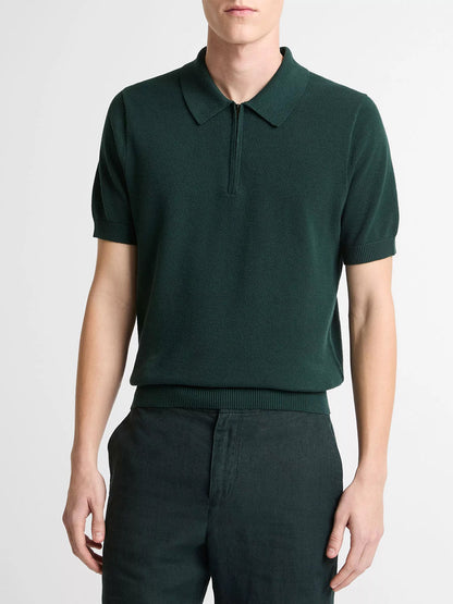 A person wearing the Vince Cotton-Cashmere Piqué Zip Polo Sweater in Seaweed with matching dark green pants stands against a plain light background.