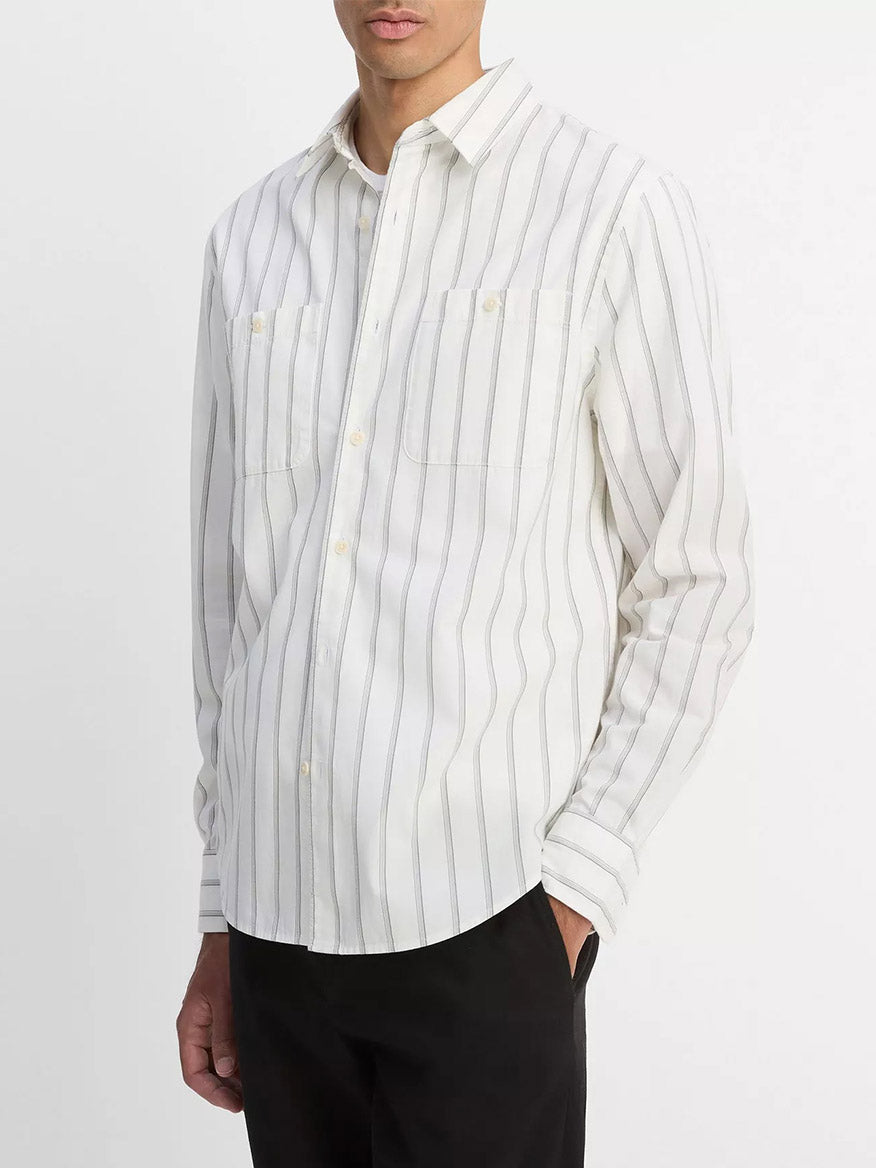 A man wearing the Vince Port Stripe Cotton Button-Front Shirt in Off White/Smoke and black pants stands against a plain background.
