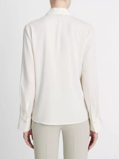 Rear view of a person wearing an elegant Vince Stretch-Silk Long-Sleeve Polo Blouse in Off-White.