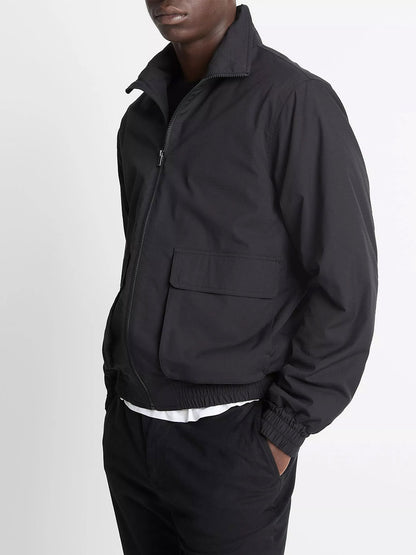 A person wears the Vince Italian Cotton Ripstop Bomber Jacket in Black with black pants, standing against a plain white background.