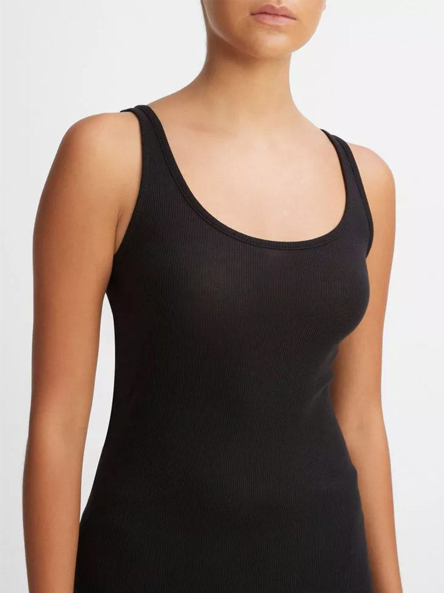 A person wearing a Vince Scoop Neck Tank in Black, with a focus on the garment's soft texture.