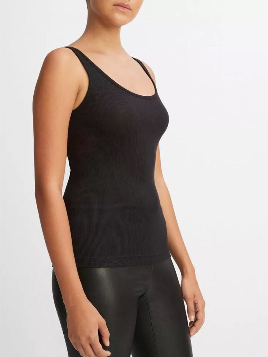 Woman wearing a soft, black Vince Scoop Neck Tank and black leggings.