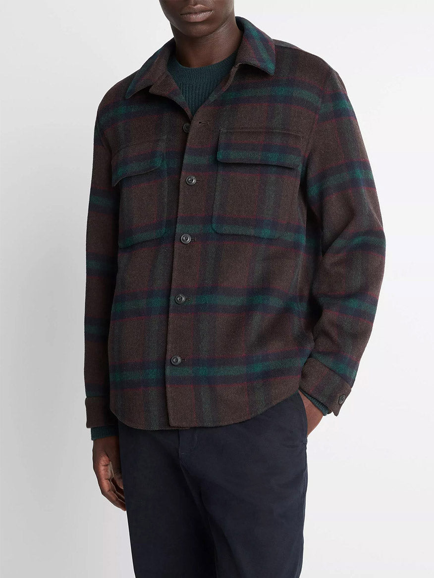 A person wearing the Vince Plaid Splittable Wool-Blend Shirt Jacket in Coastal Country Racer with two chest pockets and dark pants, standing against a plain light background.
