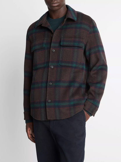 A person wearing the Vince Plaid Splittable Wool-Blend Shirt Jacket in Coastal Country Racer with two chest pockets and dark pants, standing against a plain light background.