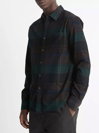 A person is wearing the Vince Sierra Plaid Cotton Corduroy Shirt in Surplus Olive/Ivy Sky with black pants, standing against a white background.