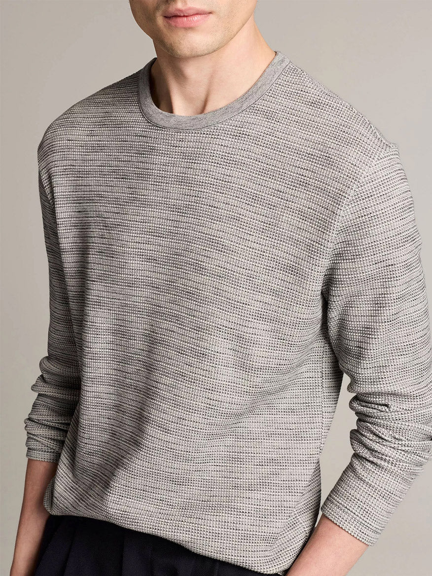 A person wearing the Vince Space-Dye Cotton-Blend Thermal Long-Sleeve T-Shirt in Late Evening Combo stands against a plain background, with their face partially out of frame.